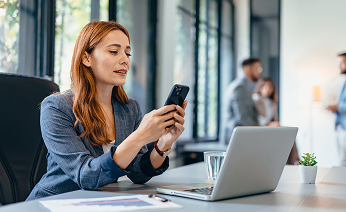 woman with mobile phone and laptop